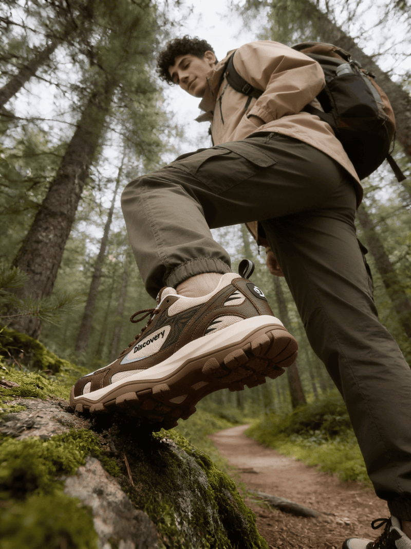 Person hiking in a forest wearing hiking shoes and a backpack.