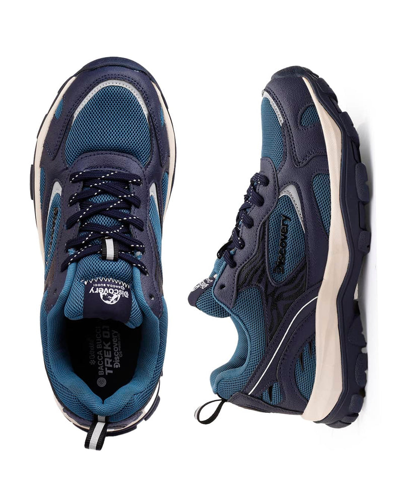 Pair of blue athletic shoes with white soles on a white background