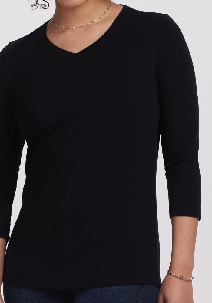 The Woolx Elena 3/4 Sleeve V Neck - Black, crafted from soft merino wool, pairs elegantly with a gold chain necklace and stands out against a plain white background.