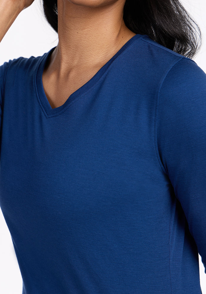 Woman wearing the Woolx Elena 3/4 Sleeve V-Neck in Estate Blue, shown shoulders to mid-torso on white background.