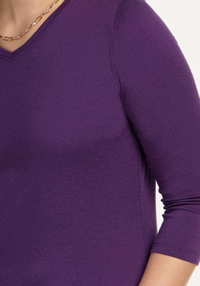 Close-up of a person wearing the Woolx Elena 3/4 Sleeve V Neck in Plum Crush with a gold chain necklace.