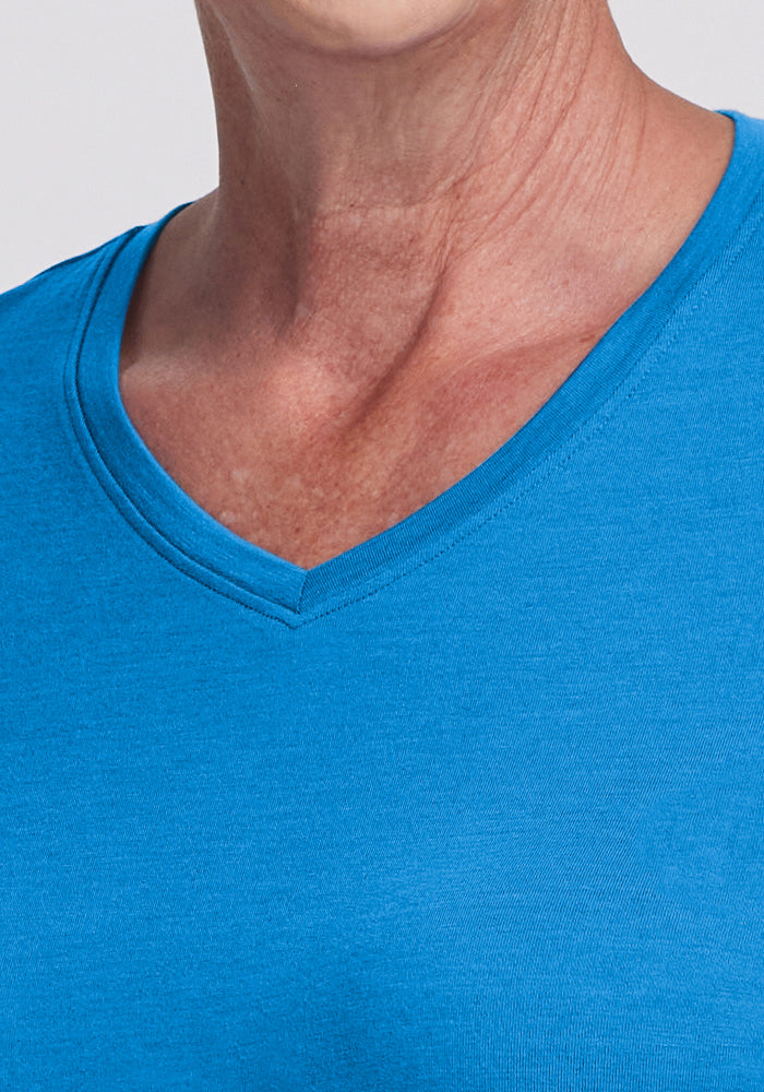 Close-up of a person wearing the Woolx Elena 3/4 Sleeve V Neck in Wave Rider, highlighting the neckline and fit.