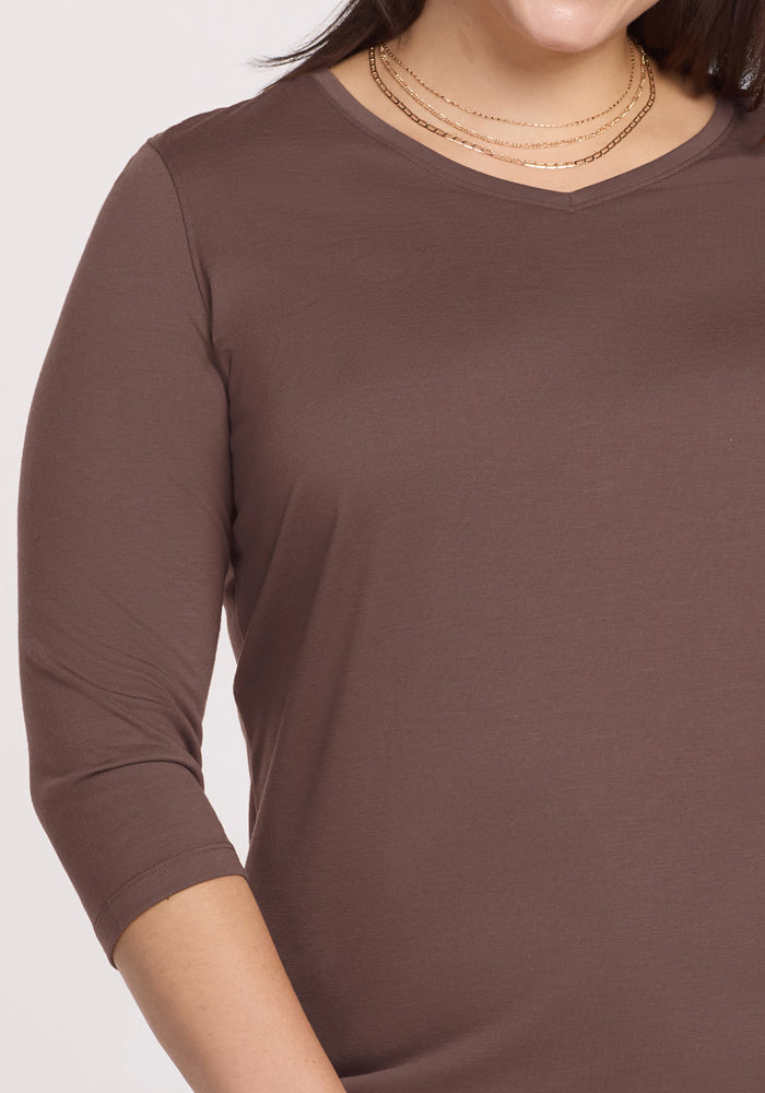 Woman wearing the Woolx Elena 3/4 Sleeve V Neck in Peppercorn with layered gold necklaces, shown shoulders to mid-arm.