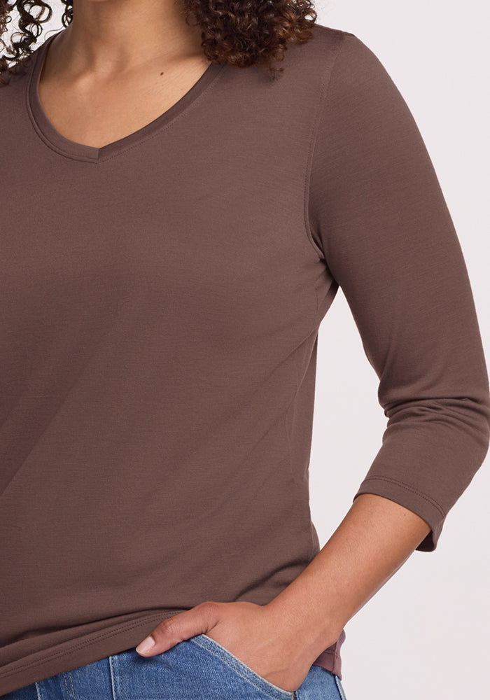 Person wearing the Woolx Elena 3/4 Sleeve V Neck in Peppercorn, paired with blue jeans and hand in pocket.