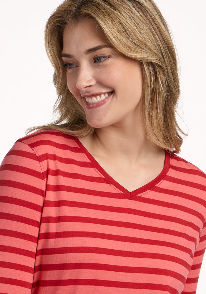 Blonde woman smiles, looking to the side in the Woolx Elena 3/4 Sleeve V Neck - Wildberry Stripe top.