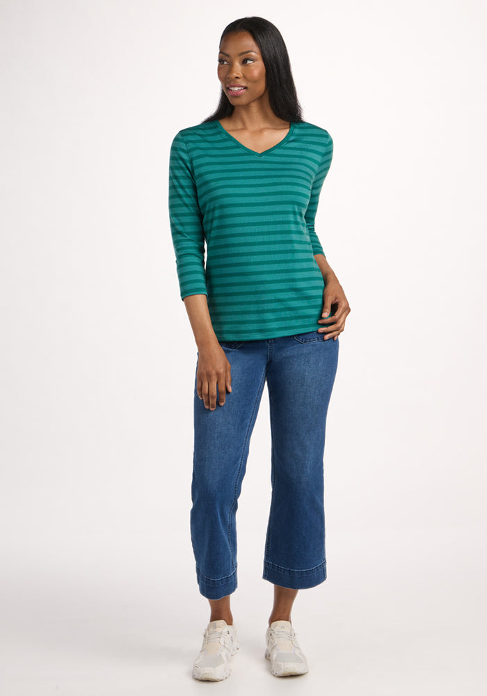 Woman wears the Woolx Elena 3/4 Sleeve V Neck - Woodland Stripe top, blue cropped jeans, and white sneakers.