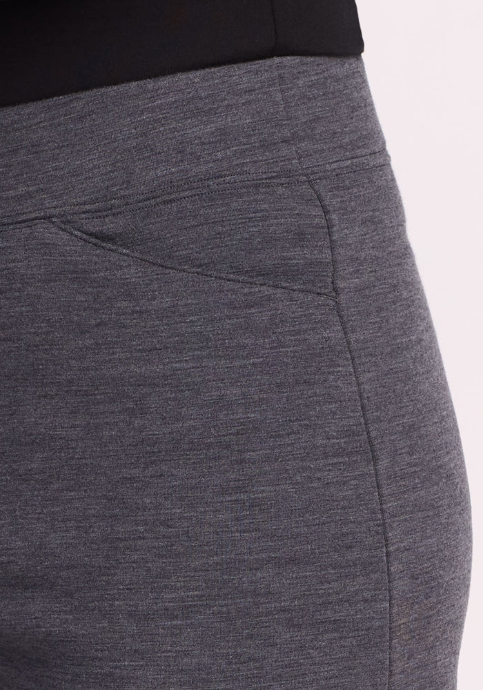 Close-up of a person wearing Woolx Ellie Wide Leg Pants Petite in Cinder Melange, featuring a visible side seam and pocket detail, shown from waist to upper thigh against a light background.