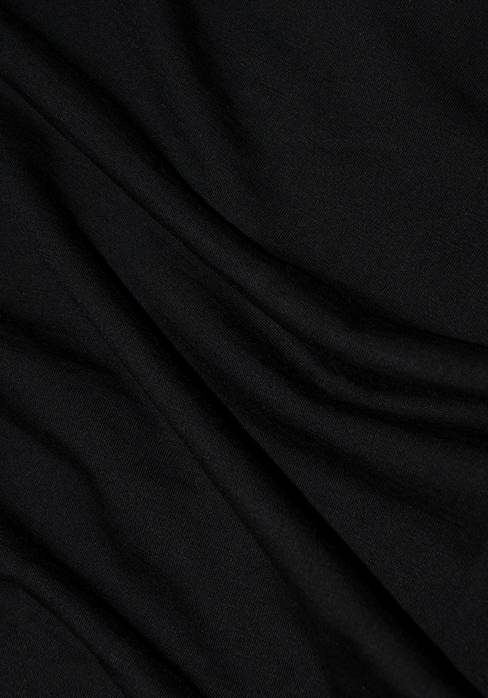 Close-up of a Woolx Endurance Tee - Black, crafted from Merino Wool, showcasing gentle folds and a soft texture for an elegant drape.