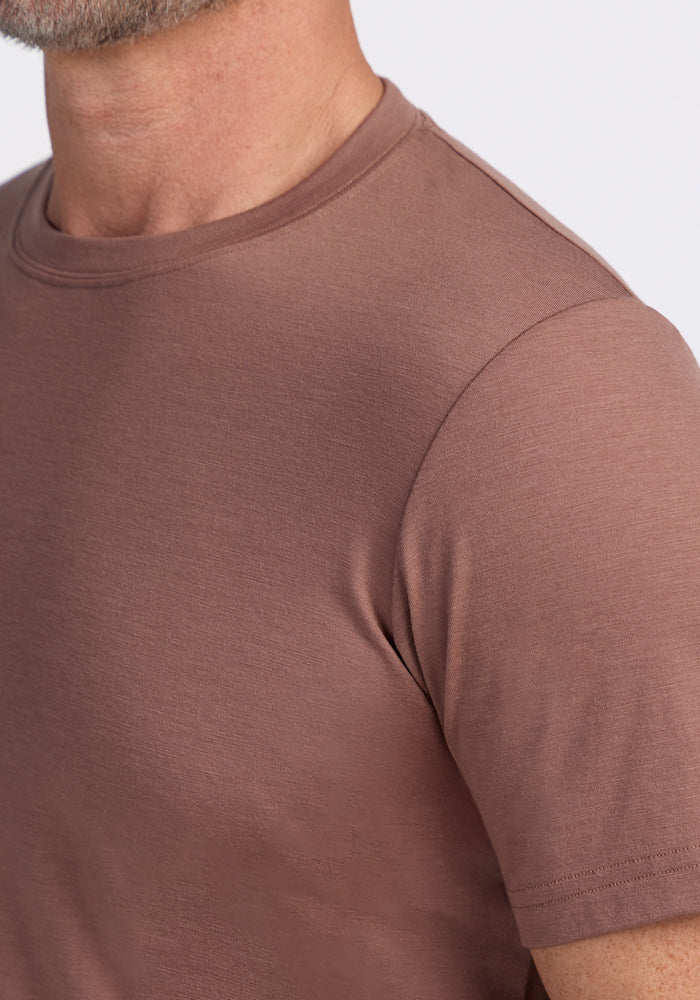 Close-up of a person in a Woolx Endurance Tee • Final Sale - Sienna Kiss, showing neck, shoulder, and upper chest.