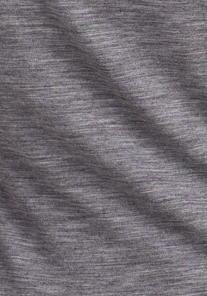 Close-up of the Woolx Endurance Tee in Graphite Heather, revealing its soft Merino wool knit and fine threads with a subtle diagonal fold—perfect for comfortable, high-performance wear.