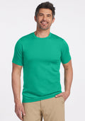 Man smiling in a Woolx Endurance Tee - Jungle and beige pants, standing against a plain white background. | Matthew is 6’, wearing a size L