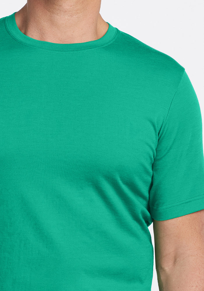 A person wearing the Woolx Endurance Tee - Jungle, shown from the neck to mid-torso.