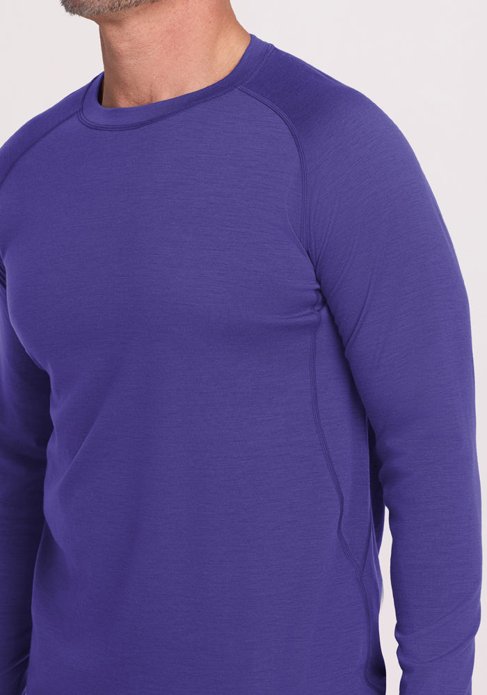 Man in Woolx Essential Tee - Berry Indigo, fitted Merino wool long sleeve; temperature regulating athletic shirt.