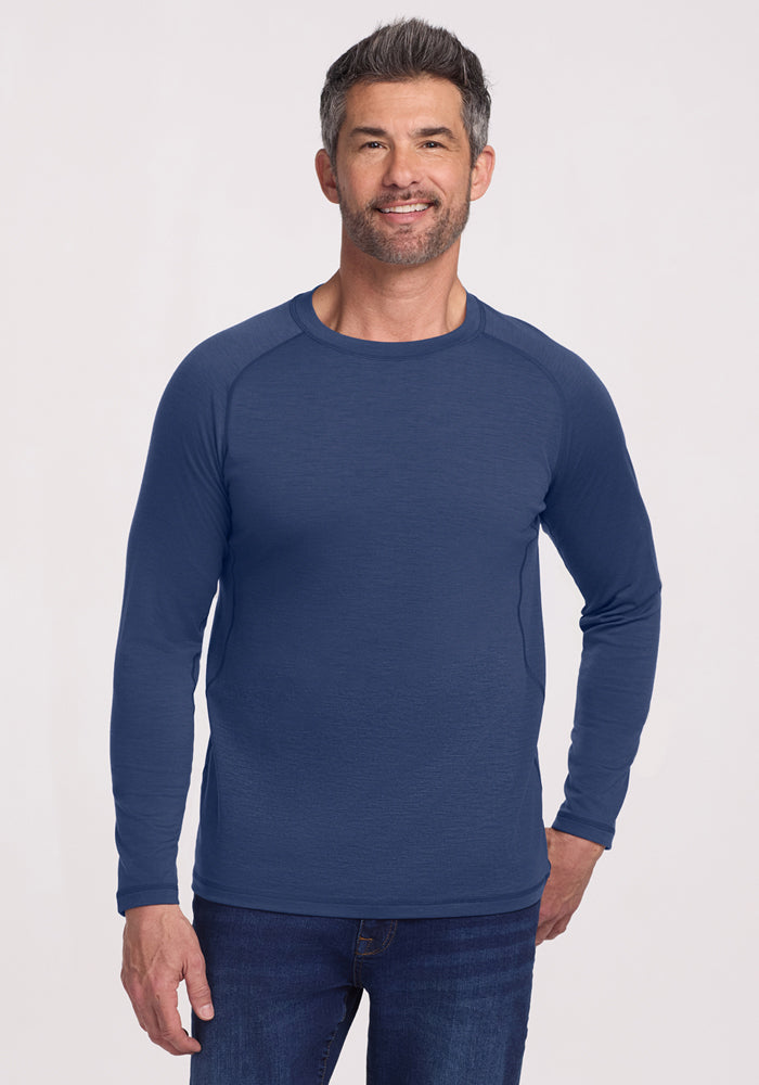 Smiling man in the Woolx Essential Tee • Final Sale - Starry Night, standing against a plain light background.