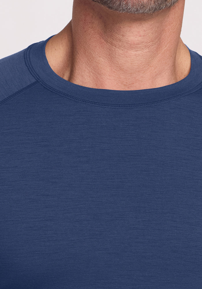 Close-up of a person wearing the Woolx Essential Tee • Final Sale - Starry Night; only neck, chin, and upper chest shown.