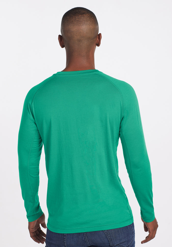 Man wearing Woolx Essential Tee - Jungle and jeans, facing away from the camera against a white background.