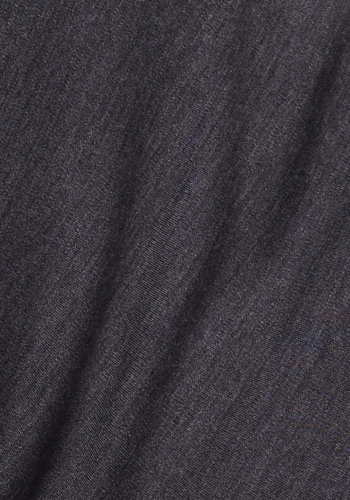 Close-up of the Woolx Eva Tunic in Cinder Melange, featuring dark gray Merino wool fabric with subtle texture and gentle folds, offering softness and slight stretch—ideal for cozy winter wear.
