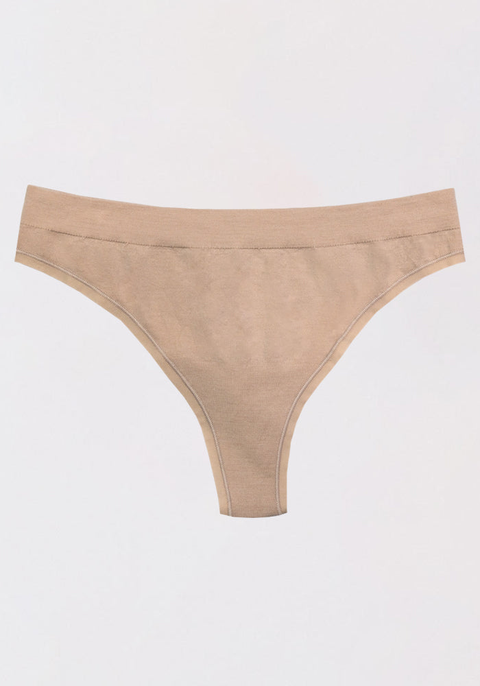 The Woolx Farrah Thong, a beige Merino wool seamless underwear with moisture-wicking properties, is shown laid flat on a plain white background.