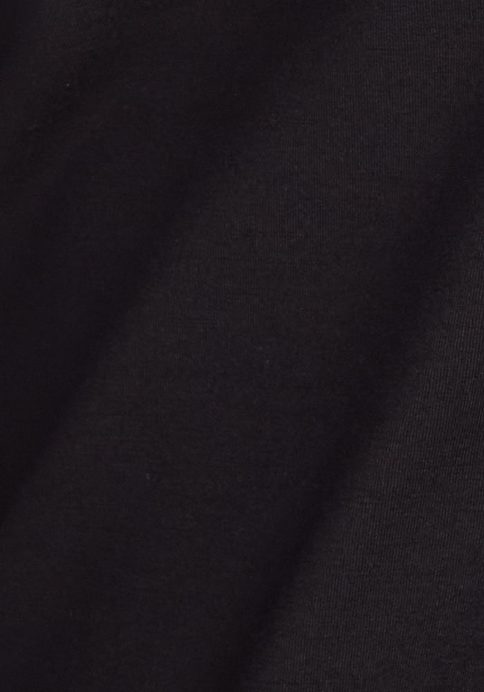 Close-up of the black Frost Petite Duralite® Leggings by Woolx, showing the soft textured fabric with gentle folds and subtle diagonal shadows—perfect for cozy winter wear.