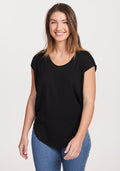 Wearing the versatile Gabi Tunic Top in black by Woolx, a person with long hair smiles while paired with blue jeans, standing against a plain white background. | Liza is 5'8", wearing a size S