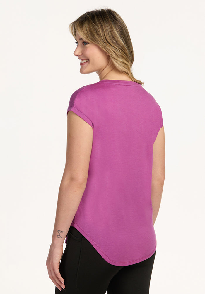 Smiling woman in the Woolx Gabi Tunic Top in Purple Wine, facing away from the camera. Final Sale.