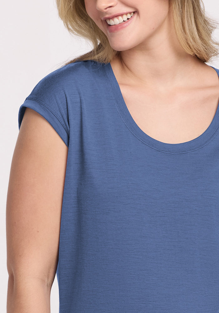 Smiling woman wears the Woolx Gabi Tunic Top in Skyline, shown from shoulders up against a light background.