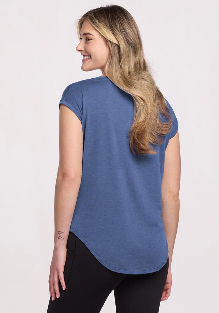 A woman in the Woolx Gabi Tunic Top • Final Sale - Skyline smiles over her shoulder, showing off the lightweight style.