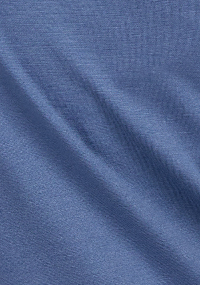 A close-up of the Woolx Gabi Tunic Top in Skyline, highlighting its soft Merino wool and smooth, folded texture.
