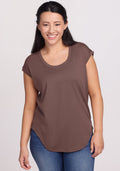 Woman in Woolx Gabi Tunic Top - Peppercorn and blue jeans smiles at the camera against a plain background. | Sarah is 5'8", wearing a size S