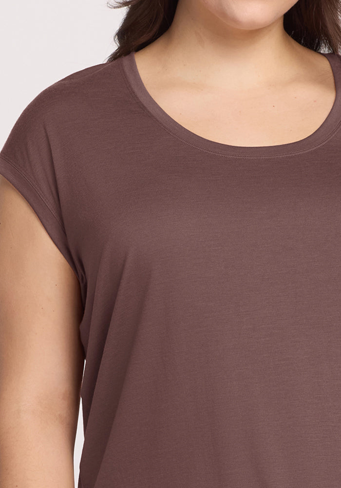 A close-up shows a person wearing the Woolx Gabi Tunic Top in Peppercorn, highlighting their shoulder and chest.