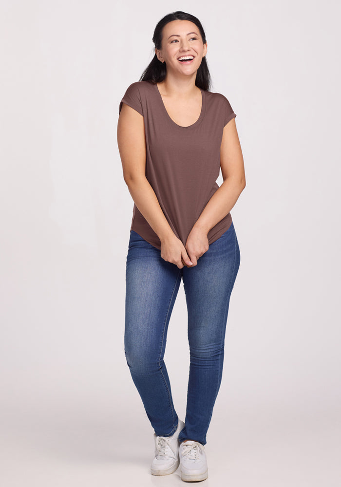 Woman wearing the Woolx Gabi Tunic Top in Peppercorn and blue jeans, smiling against a plain light background.