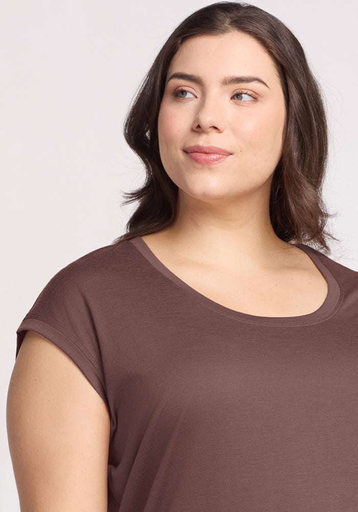 Woman with wavy brown hair smiles softly, wearing the Woolx Gabi Tunic Top in Peppercorn.