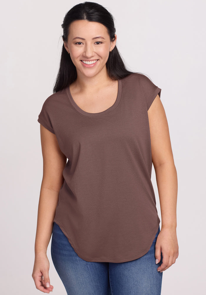 Woman in Woolx Gabi Tunic Top - Peppercorn and blue jeans smiles at the camera against a plain background. | Sarah is 5'8", wearing a size S