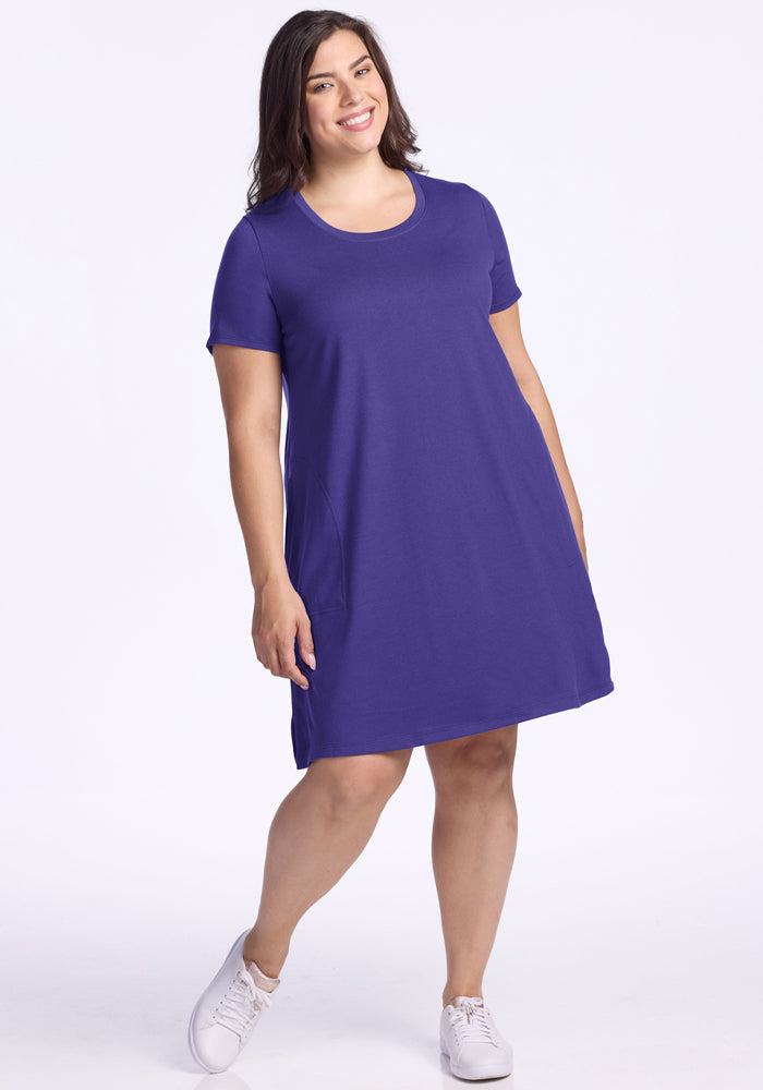 Woman in the Woolx Georgie Dress - Berry Indigo and white sneakers smiles against a white background. | Juliana is 5'10", wearing a size XL