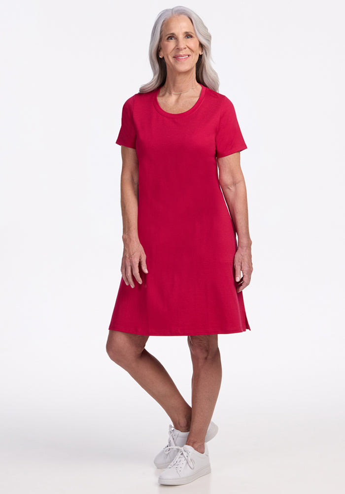 Smiling older woman in Woolx Georgie Dress • Final Sale - Poppy Spark and white sneakers with long gray hair.