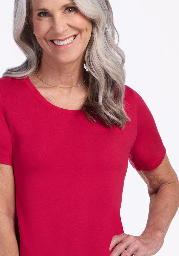 Smiling older woman in a Woolx Georgie Dress • Final Sale - Poppy Spark, hand on hip, long gray hair.