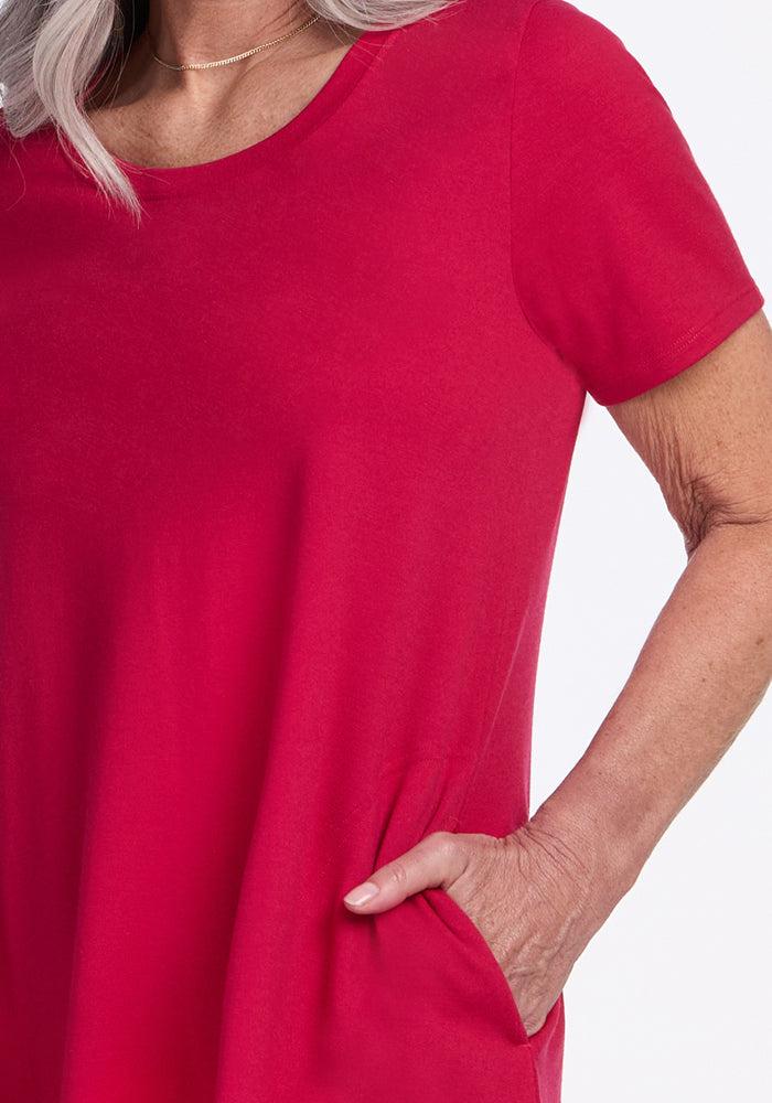 Older woman in Woolx Georgie Dress • Final Sale - Poppy Spark, hand in pocket, showing only torso and arm.