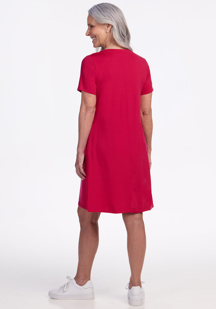 Older woman in a Woolx Georgie Dress • Final Sale - Poppy Spark, smiling with her back to the camera.