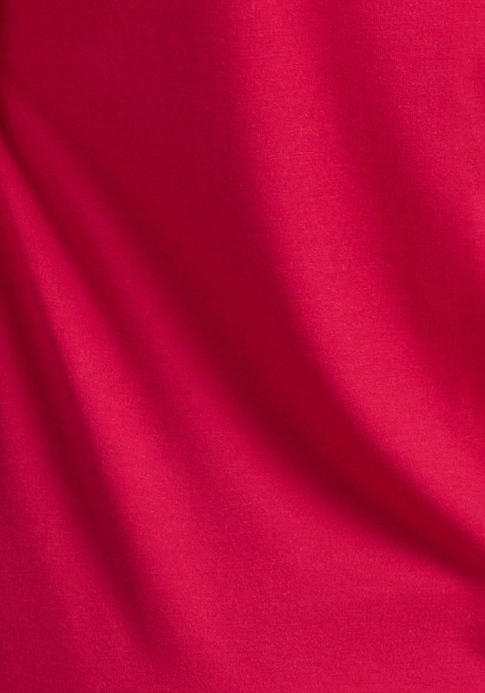 Close-up of Woolx Georgie Dress in Poppy Spark, Merino wool with soft folds for a smooth, textured look.