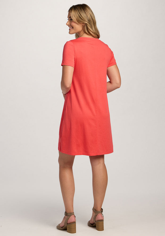 Woman standing and smiling in the Woolx Georgie Dress - Hibiscus, shown from the back.