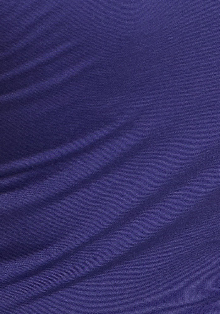 Close-up of moisture-wicking Berry Indigo Gracie Bodysuit fabric by Woolx, showing gentle folds and texture.