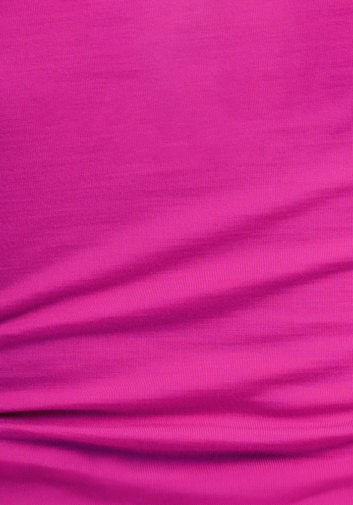 Close-up of Woolx Gracie Bodysuit - Summer Sorbet's bright pink, moisture-wicking fabric with subtle texture.