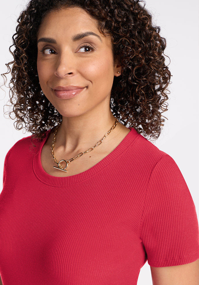 Smiling woman with curly hair in Woolx Harlowe Ribbed Dress - Berry Ice Pop—great for a travel dress ad.
