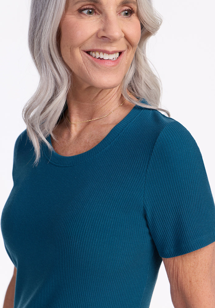 Smiling older woman in the Woolx Harlowe Ribbed Dress in Moroccan Blue, looking off to the side.