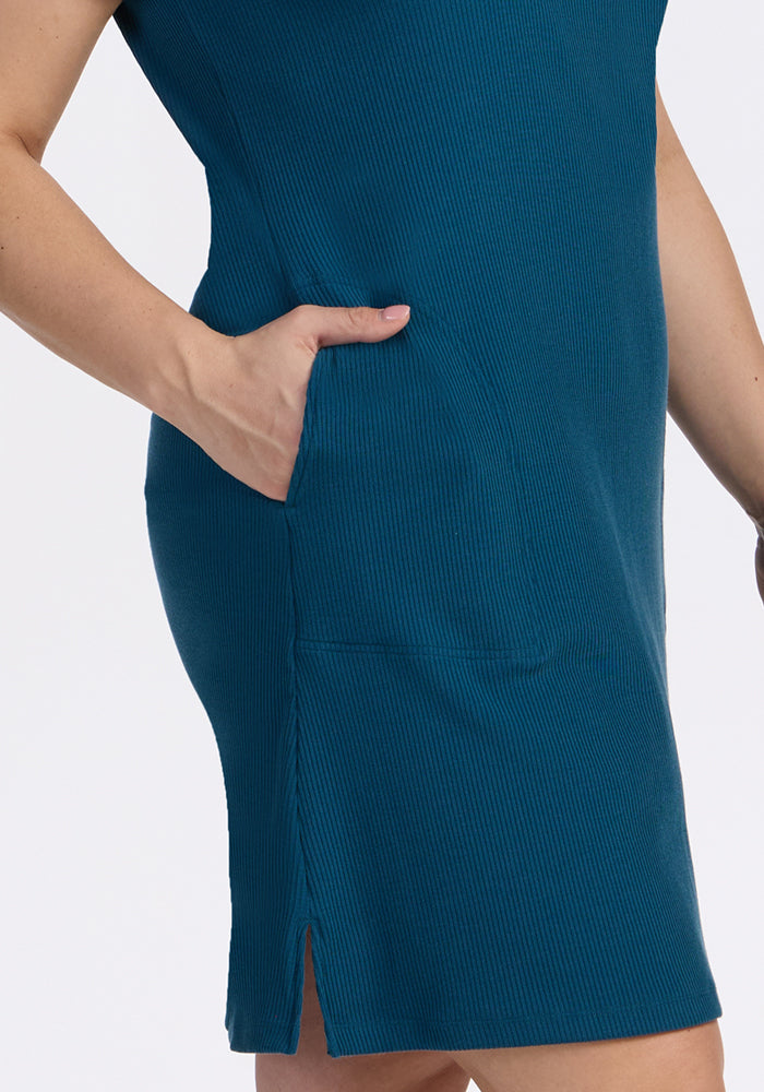 Person wearing the Woolx Harlowe Ribbed Dress in Moroccan Blue with a pocket and small side slit at the hem.