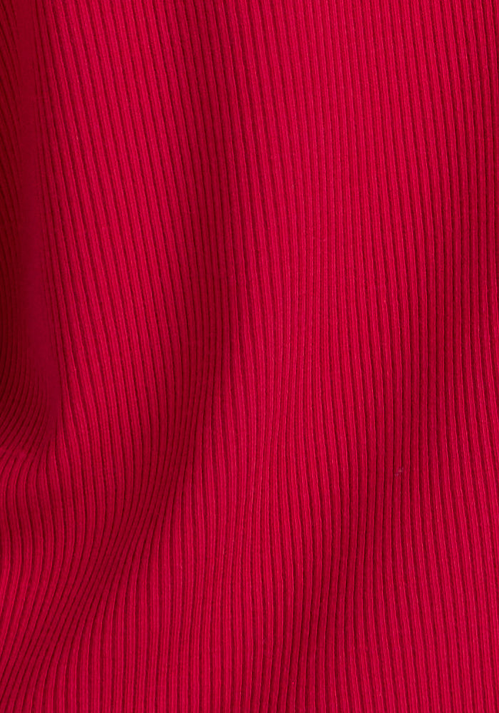Close-up of Woolx Harlowe Ribbed Dress in Poppy Spark, featuring vertical textured lines and soft folds.