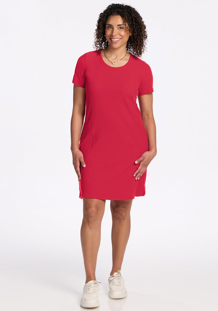 Woman with curly hair in a Woolx Harlowe Ribbed Dress - Berry Ice Pop and white sneakers, standing and smiling. | Kisha is 5'8", wearing a size M