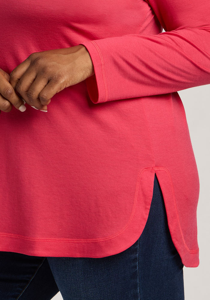 Wearing the Woolx Hazel Tunic in Berry Ice Pop and dark blue jeans, with a hand near the tunic’s hem.