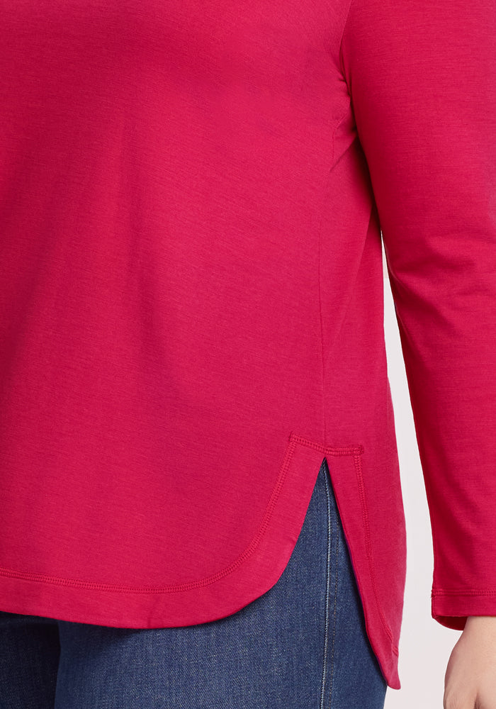 Person wearing a Woolx Hazel Tunic • Final Sale - Poppy Spark with blue jeans, showing torso and arm.