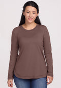 A woman wears the Woolx Hazel Tunic in Peppercorn with blue jeans, standing forward and smiling slightly. | Sarah is 5'8", wearing a size S